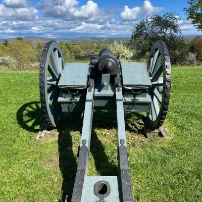 Historical cannon overlooking a valley and distant mountains