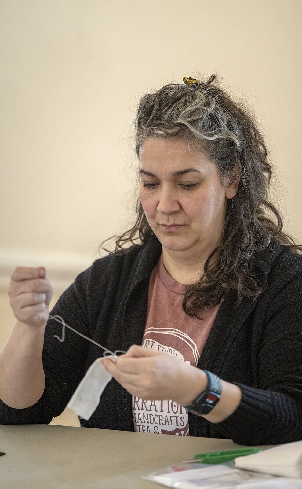 Sophie Stanley of Milton pulls a thread through the first portion of a woman's cap during a historical sewing session for reenactors and volunteers for the Saratoga 250th events, Saturday, Feb. 22, 2025 at Brookside Museum in Ballston Spa.