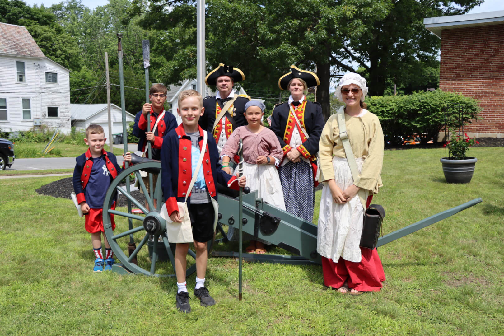 Revolutionary War reenactors gathered around a historical cannon