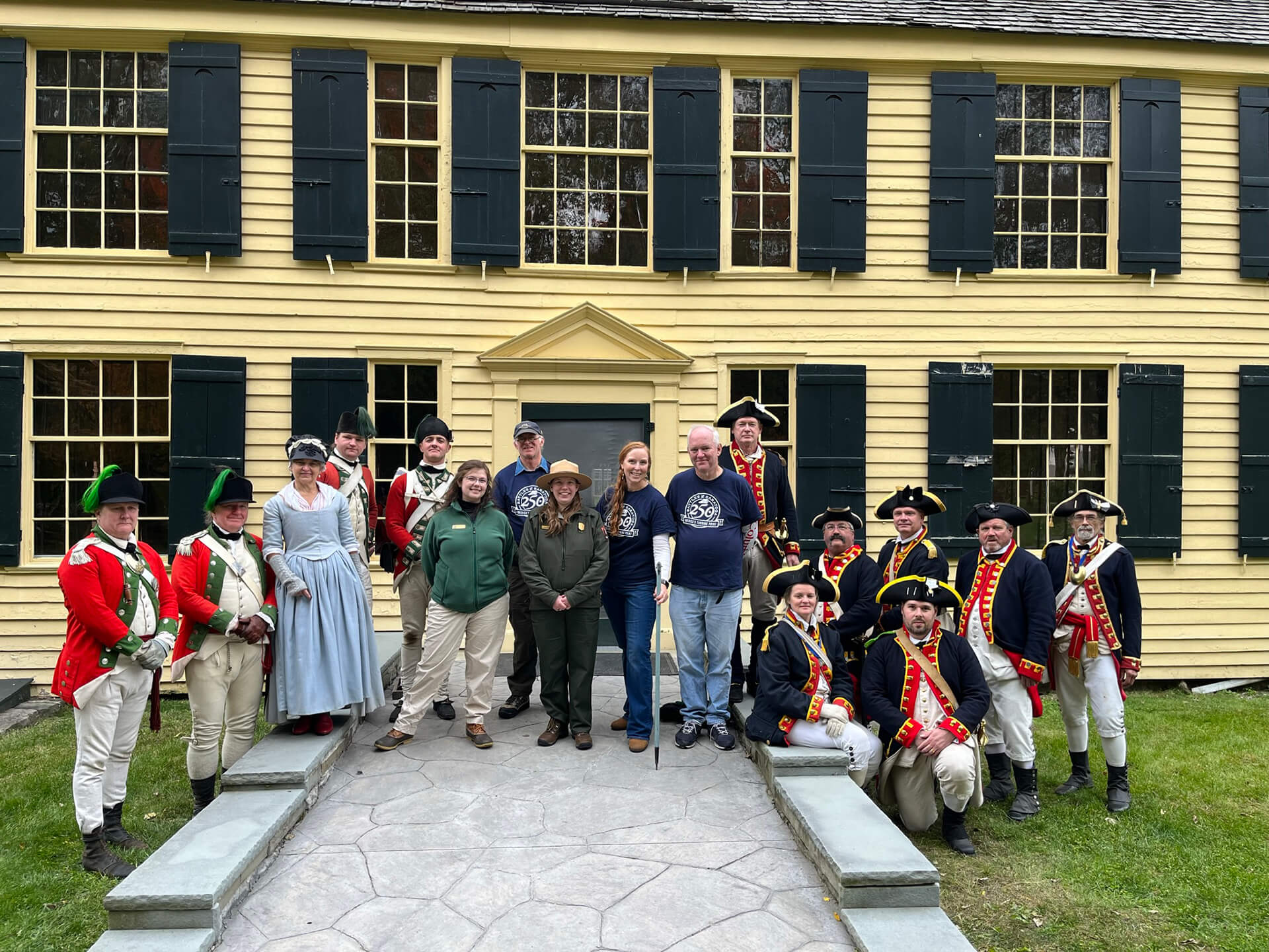 People from the National Park Service, Saratoga 250, and reenactors in front of The Schuyler House